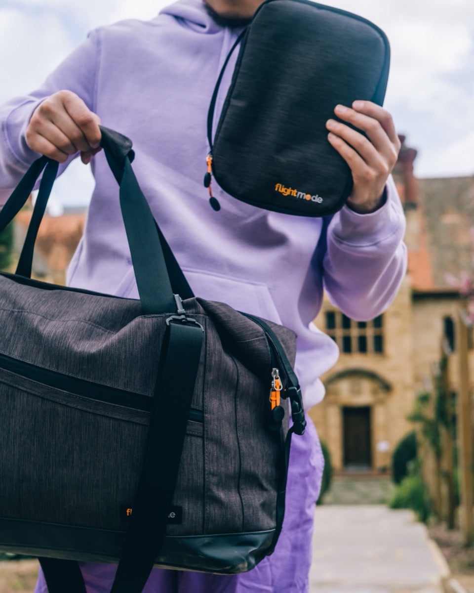 man carrying duffel bag